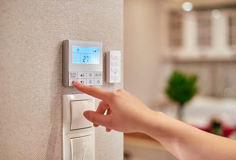 Woman Checking Thermostat Woman Checking Thermostat