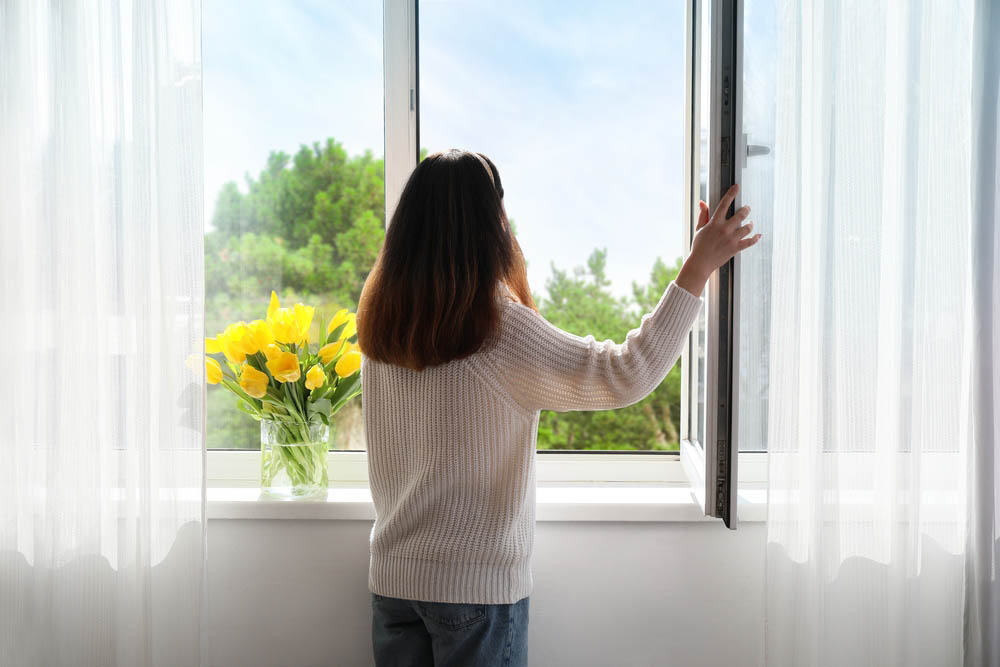 woman opening window in Monterey, TN